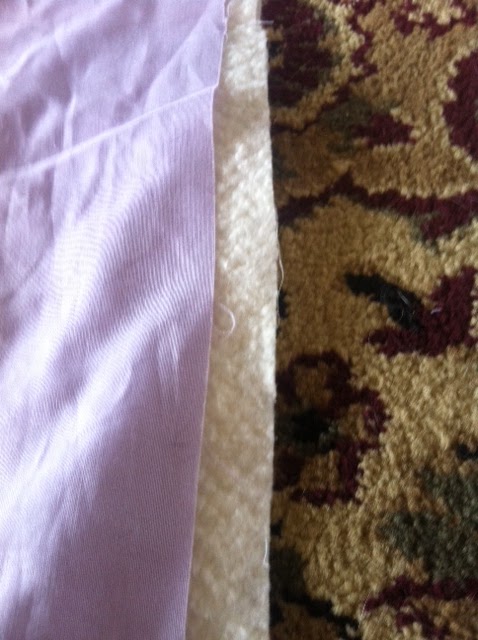 edge of fabric over quilt batting.