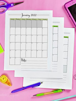 printable 2024 calendars stacked on a desk.