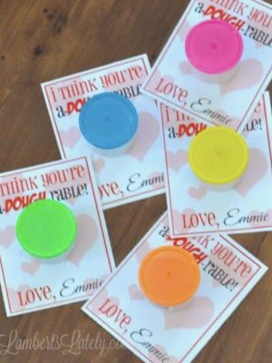 play dough valentine printables with tubs of play doh on top.
