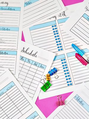 vacation planning printables spread around office supplies.