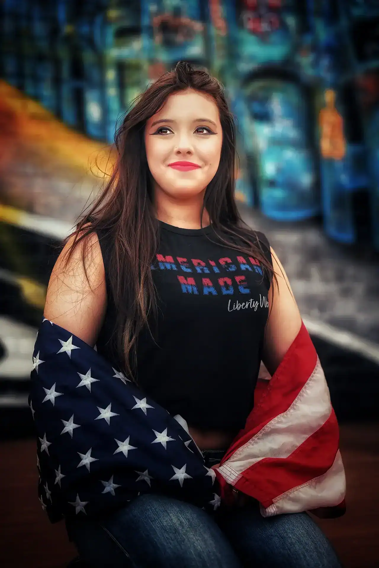 A girl with an american flag on her shoulders