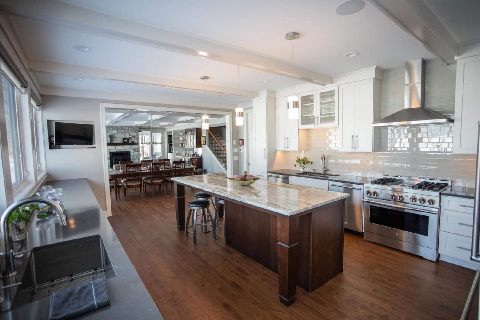 Modern Livingston Homes kitchen with white cabinets and stainless steel appliances.