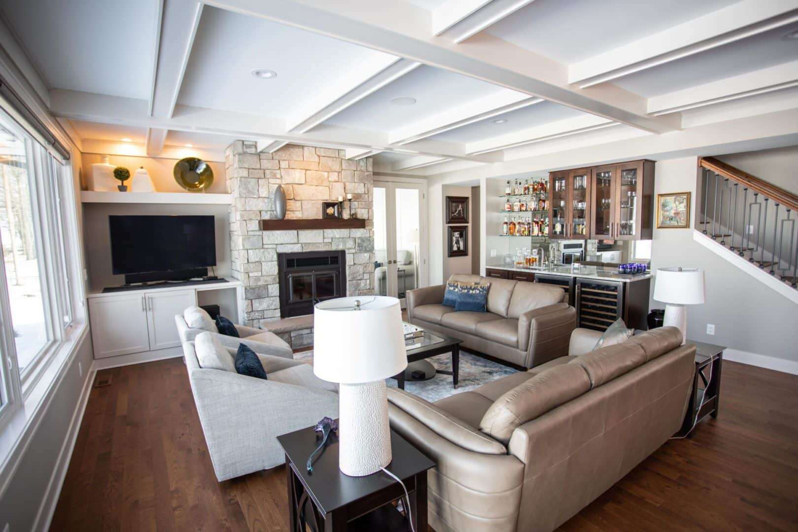 Livingston Homes living room with cozy seating, fireplace, and built-in bar area. Perfect for family.