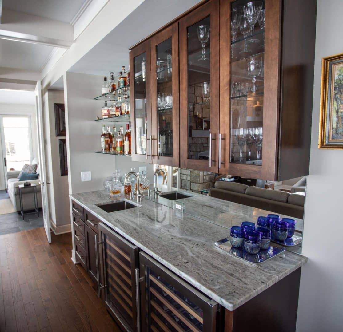 Modern kitchen with granite countertops, glass-front cabinets, and built-in wine cooler.