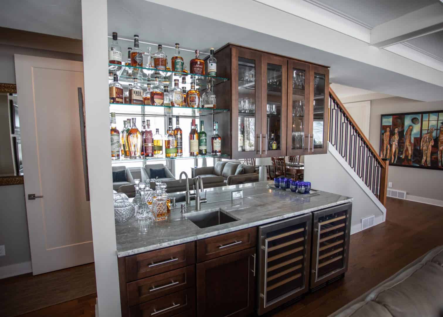 Living Livingston Homes interior featuring a stylish bar area with liquor bottles and wine fridge.