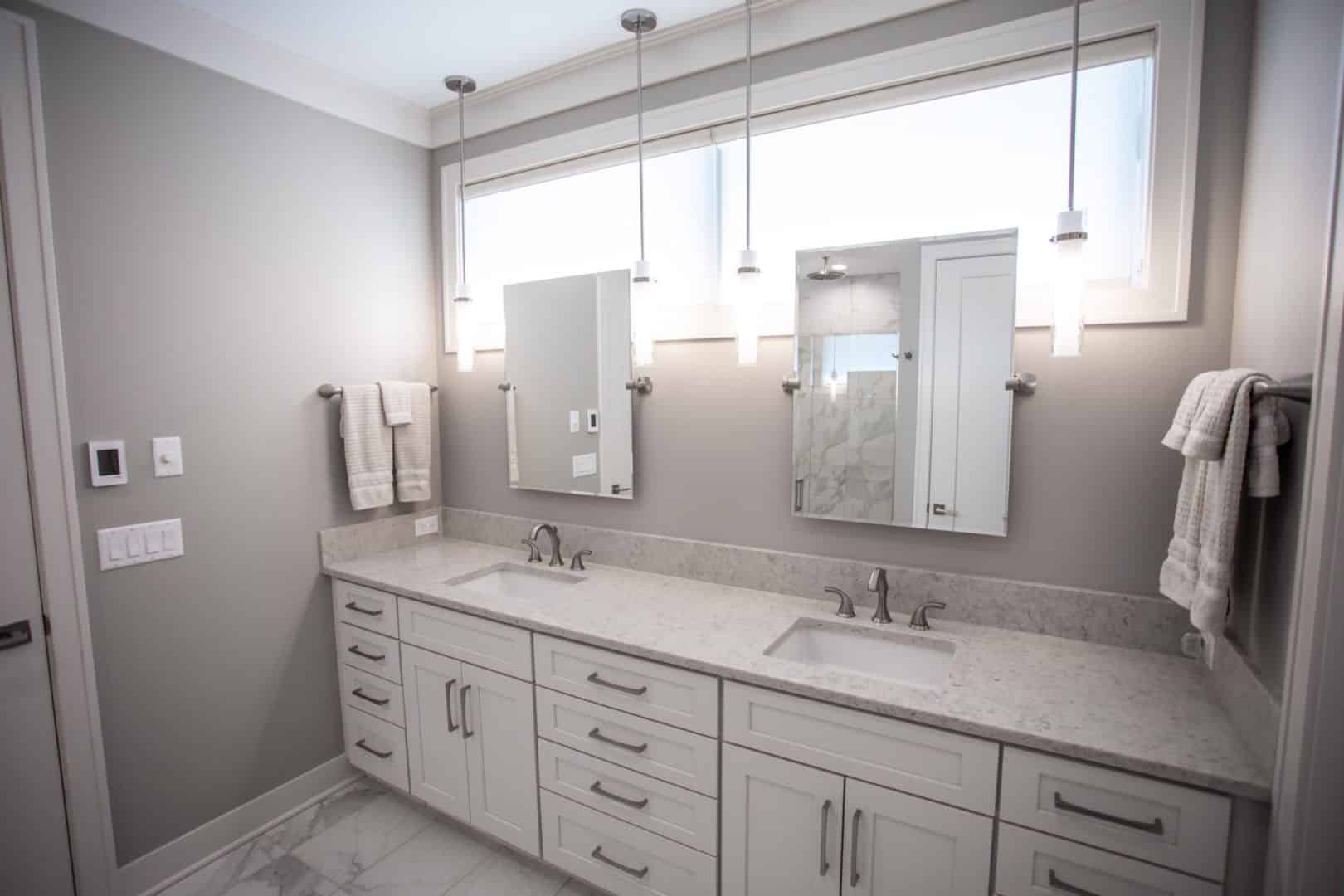 Bathroom vanity with double sinks, large mirror, and modern fixtures for stylish functionality.