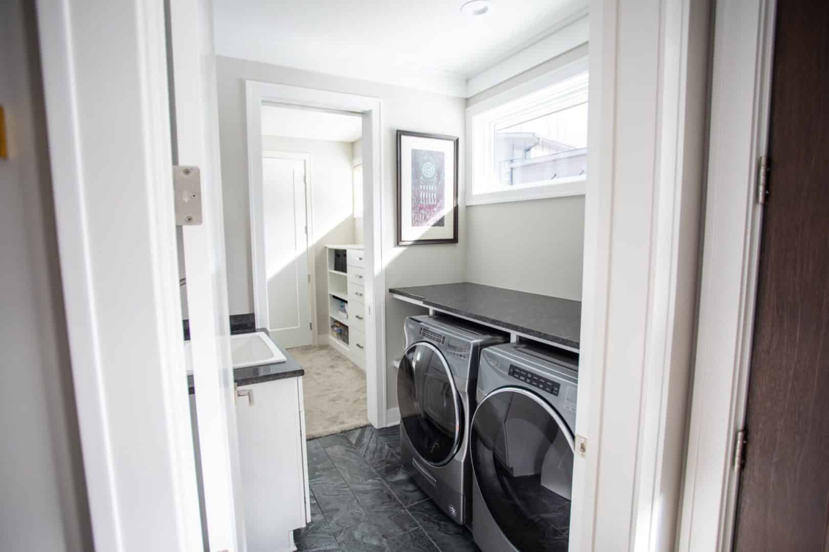 Laundry room with washer and dryer in Livingston Homes house.