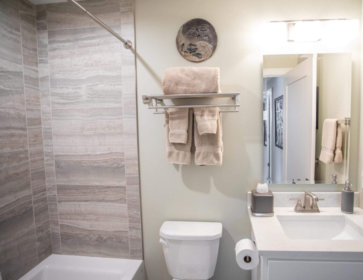 Bathroom with shower, toilet, and vanity in a contemporary home.