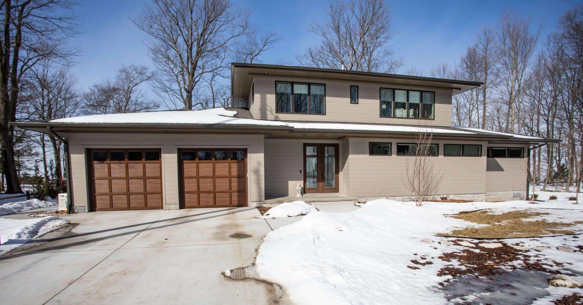 Contemporary two-story house with garage in Livingston, winter scene.