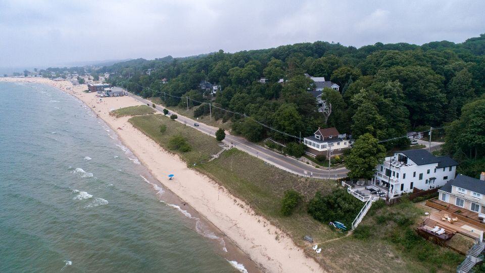 Aerial view of Livingston Homes beachfront properties and scenic coastline.