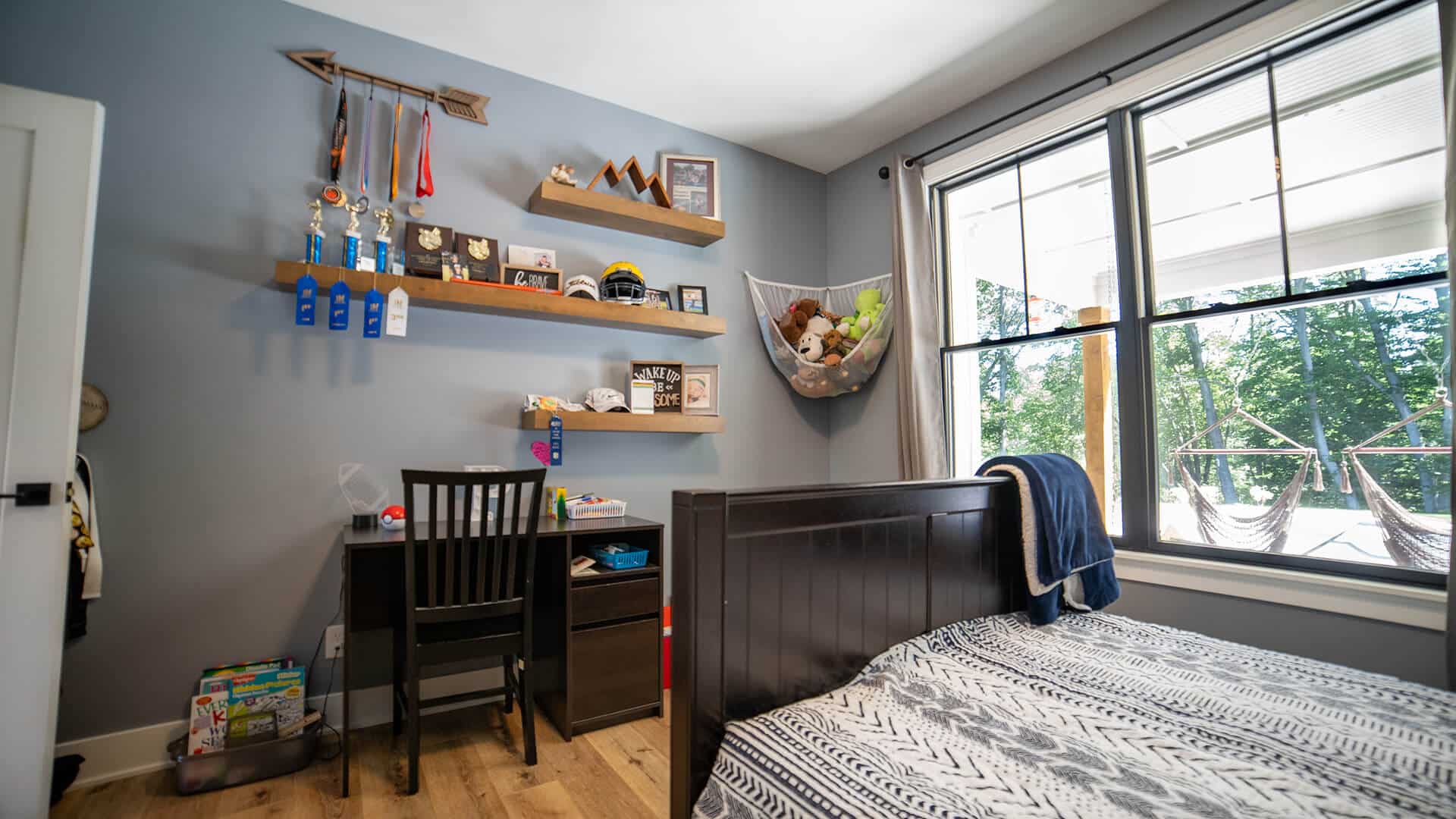 Bright bedroom featuring a large window, modern decor, and a comfortable bed for relaxing living spa.