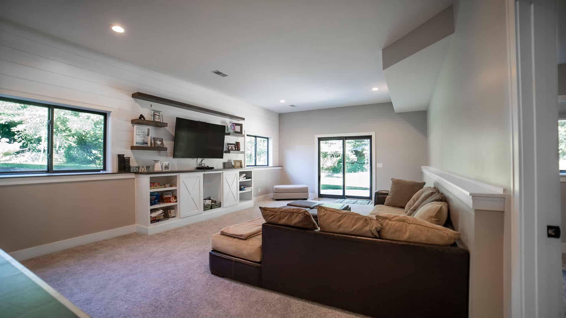 Modern living room with large windows and cozy seating.