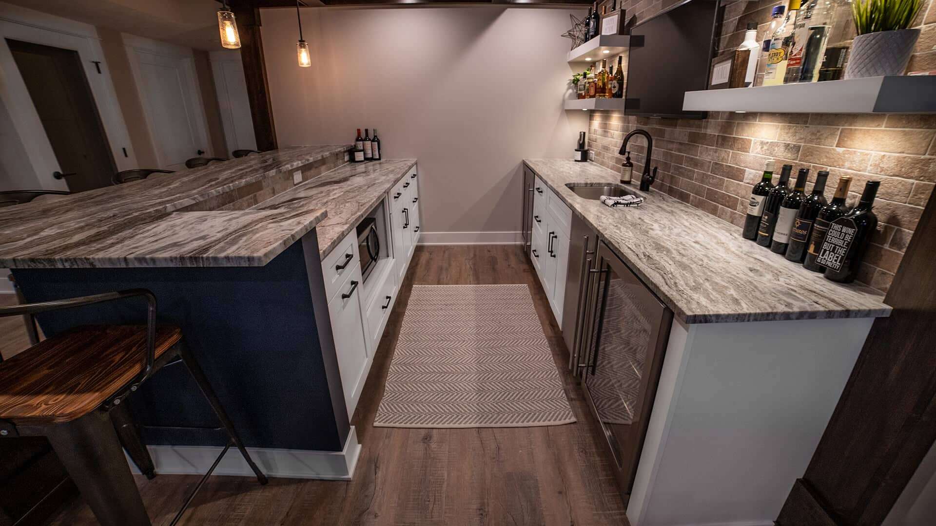 Kitchen with granite countertops, brick backsplash, and modern appliances.