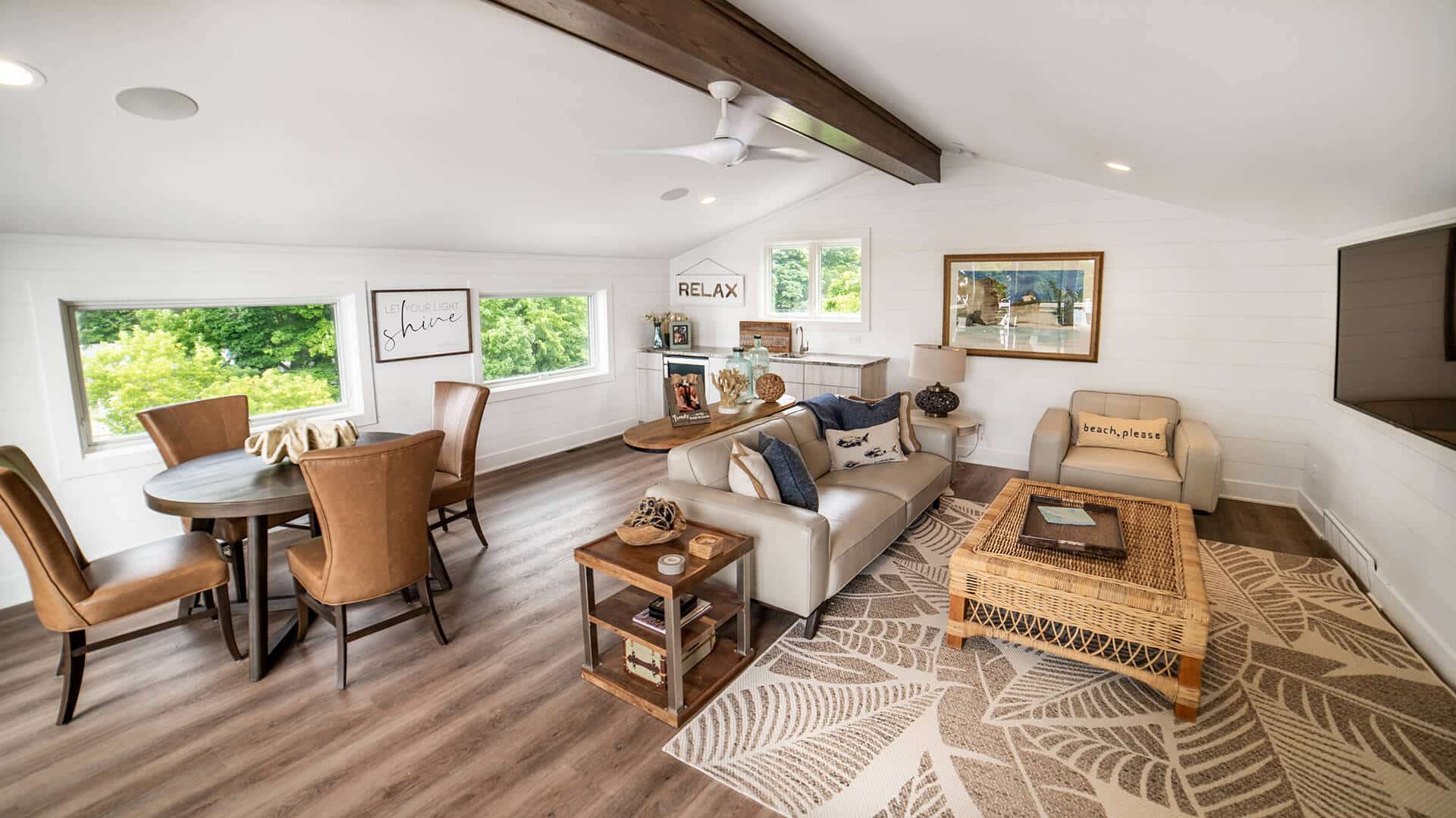 Bright and spacious living room with large windows, modern furniture, and stylish decor.