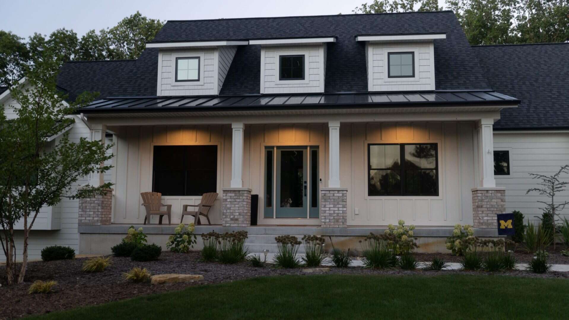 Beautiful modern craftsman style house with front porch and dormer windows.