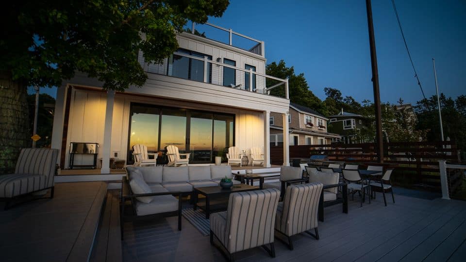Beautiful outdoor deck with seating and sunset view in Livingston Homes property.