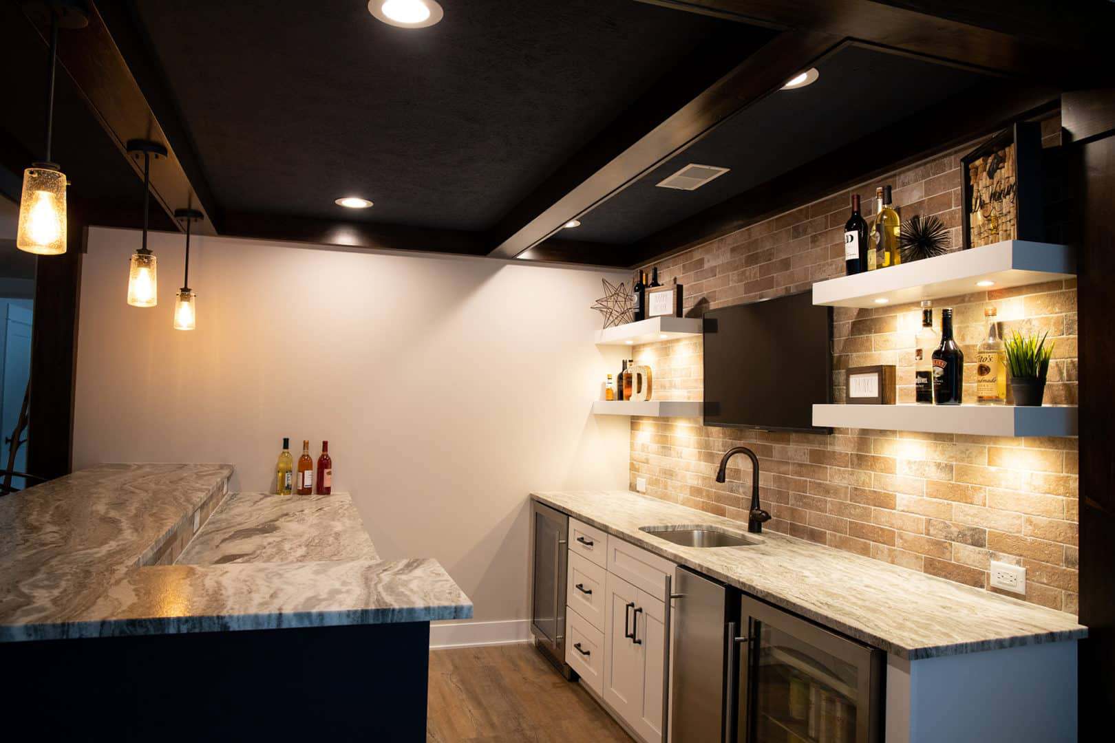 Modern kitchen with stylish brick backsplash and elegant shelving.