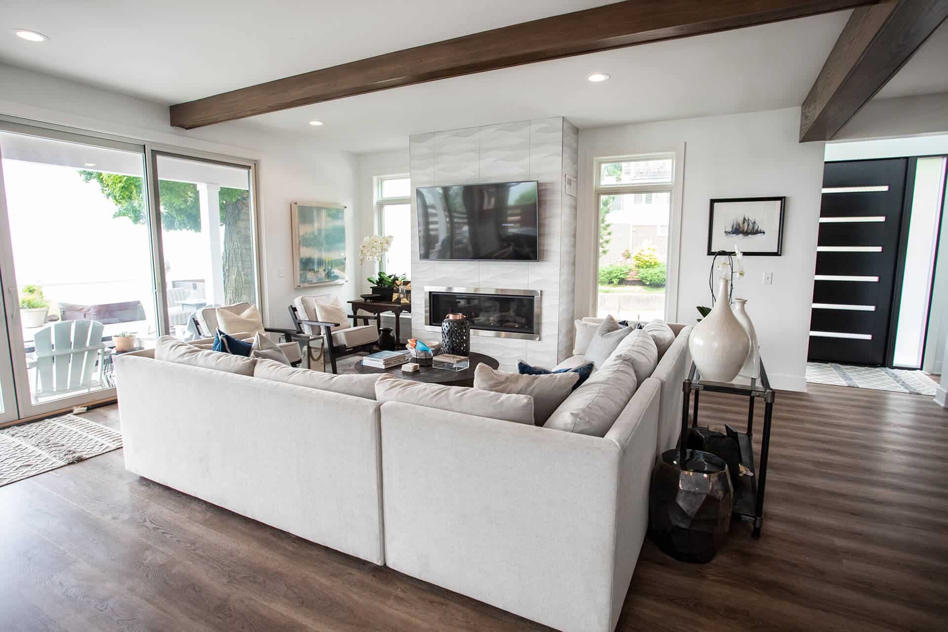 Living room featuring a fireplace, large windows, and contemporary decor in a Livingston Homes prope.
