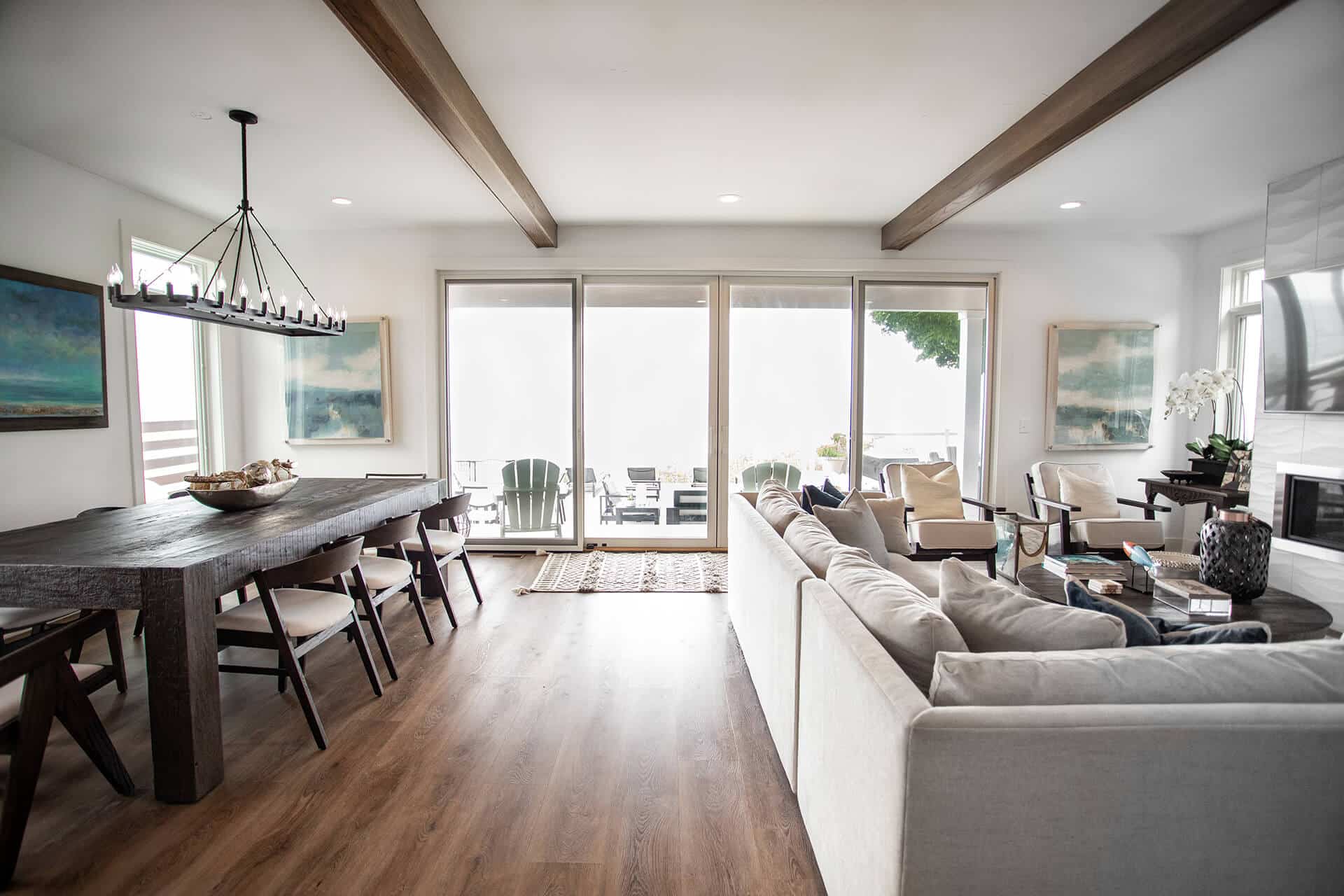Livingston Homes, modern living room with large glass doors, stylish furniture, and natural light.