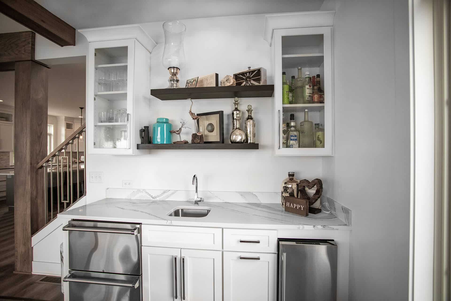 Modern white kitchen with open shelving and stainless steel appliances.