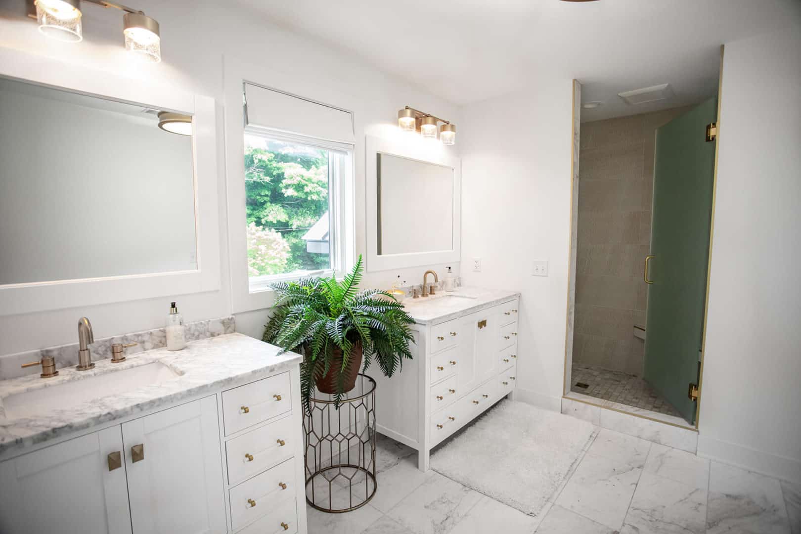Modern bathroom with double vanity and walk-in shower.