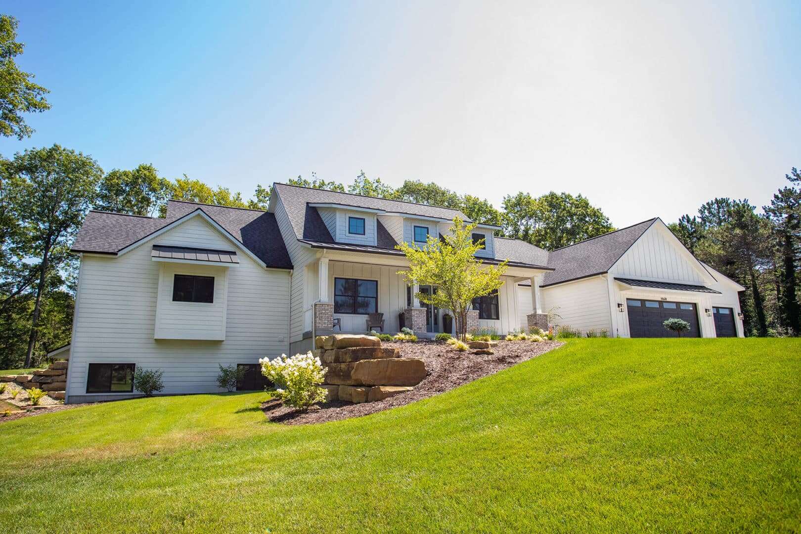 Livingston Homes modern house with spacious yard and landscaped garden.