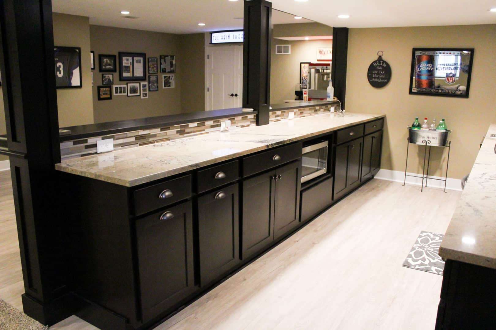 Elegant kitchen with black cabinets and granite countertops for stylish living.