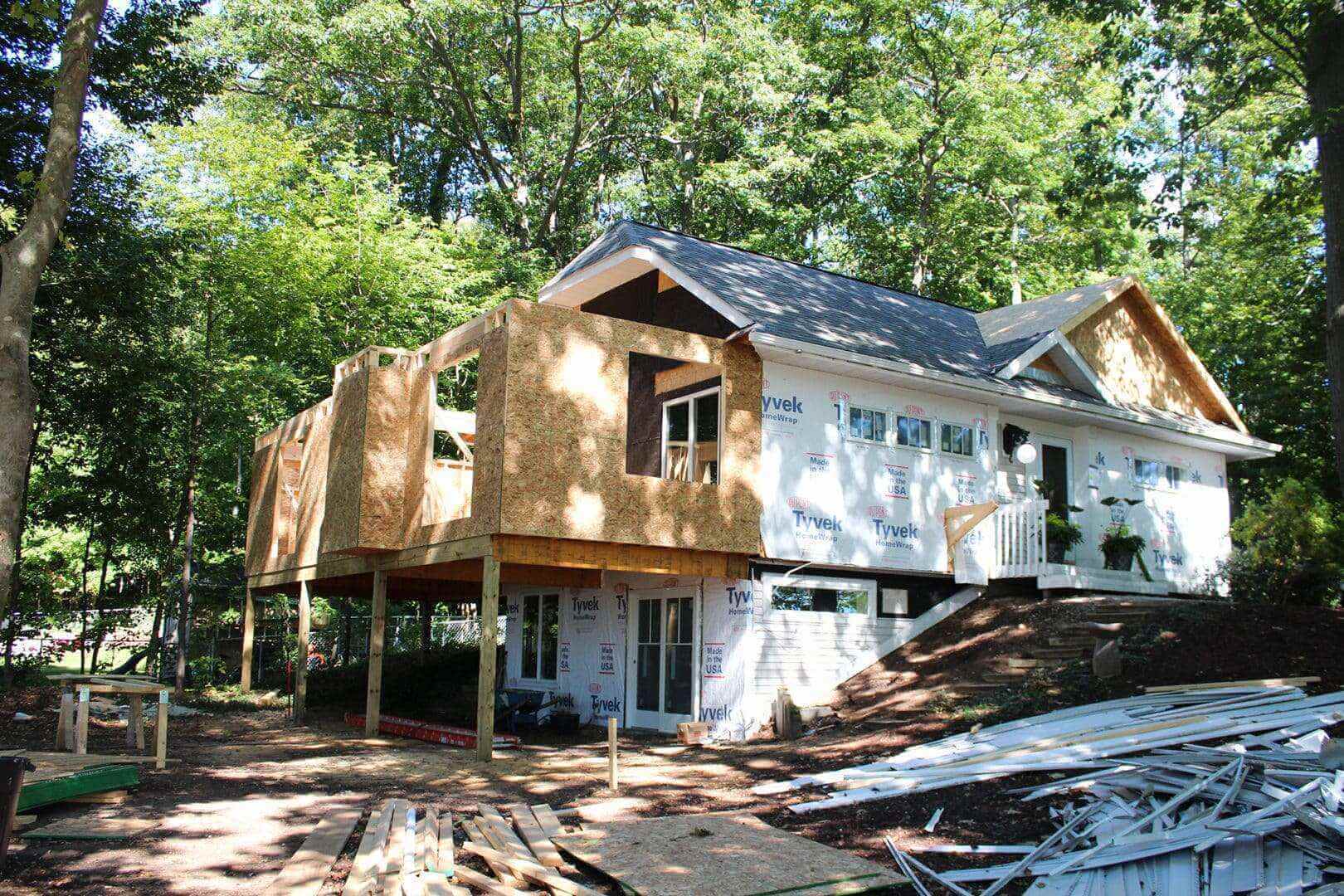 New residential home under construction in a wooded area.