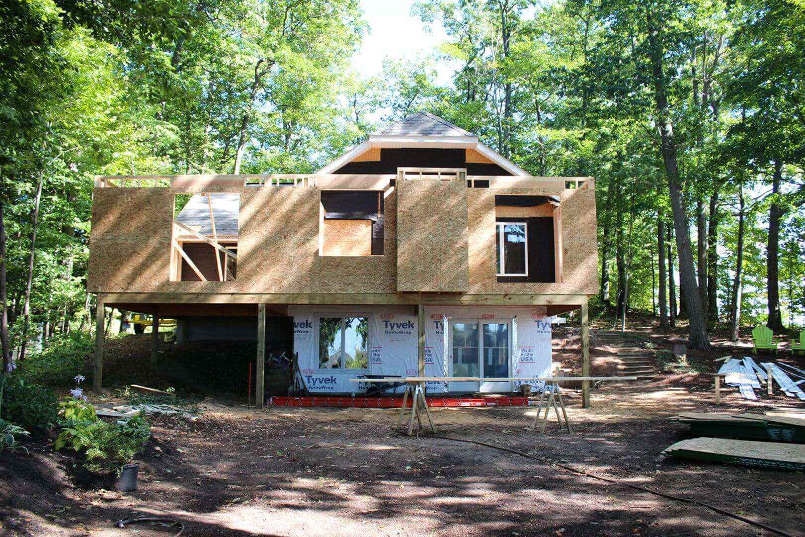 New residential home under construction in wooded area.