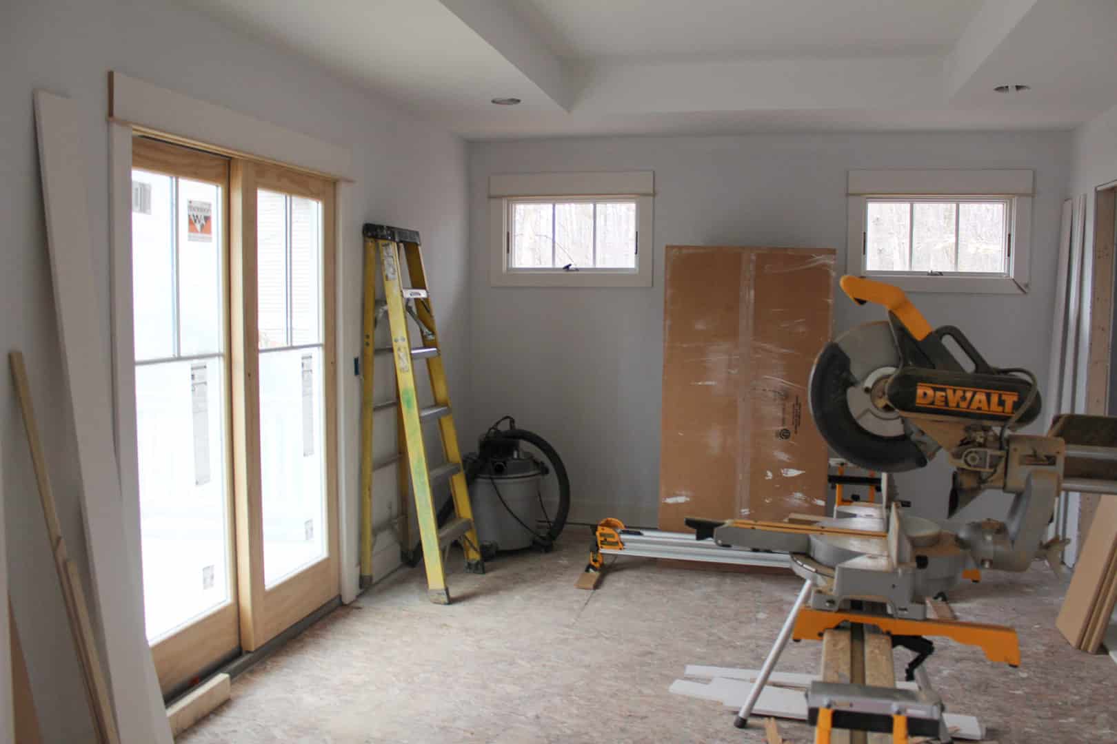 Interior room under renovation with construction tools and materials.
