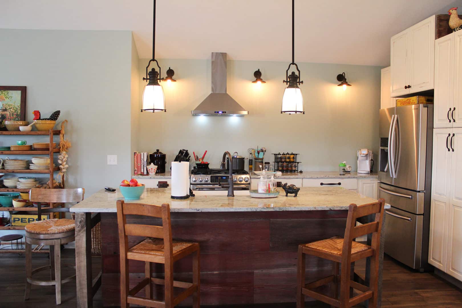 Bright modern kitchen with island and stainless steel appliances.