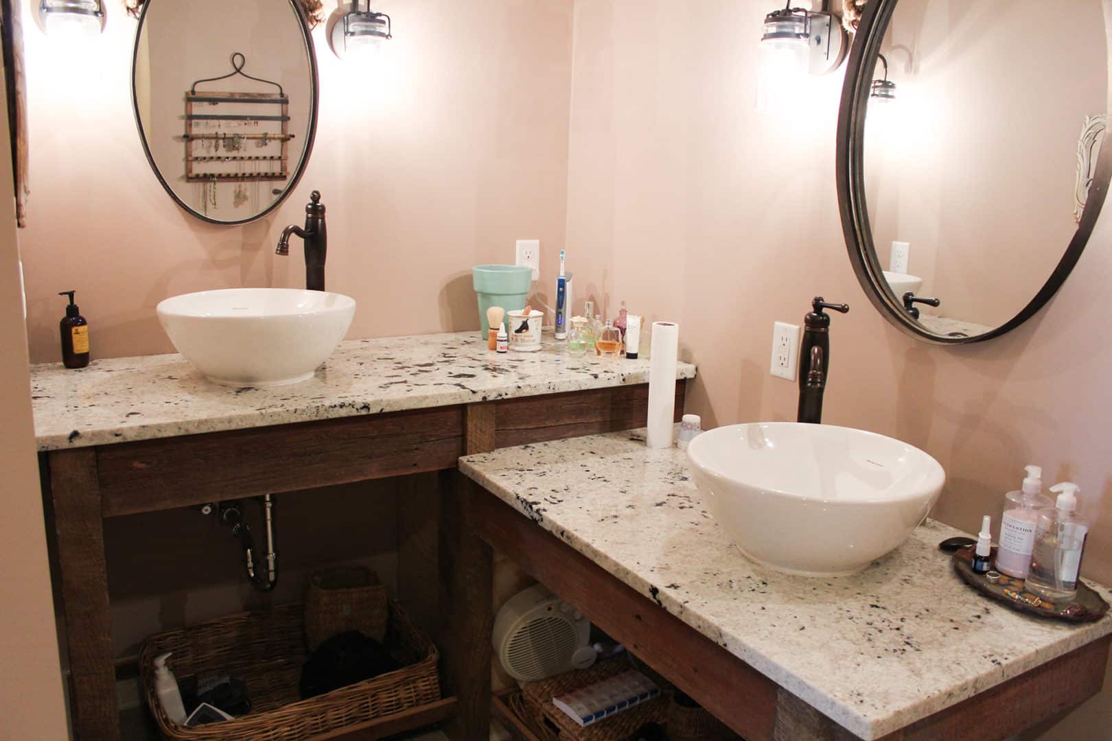 Double sink bathroom vanity with granite countertops and stylish mirrors.