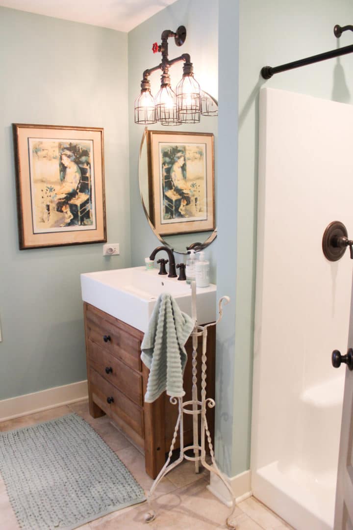 Bathroom vanity with sink, mirror, and decorative lighting.