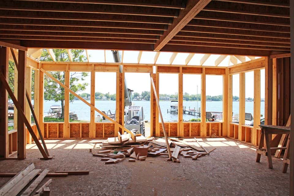 Livingston Homes waterfront construction site with framing in progress.