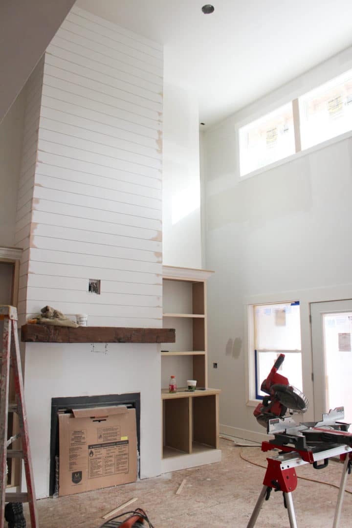 Livingston Homes - Modern living room with fireplace under construction.