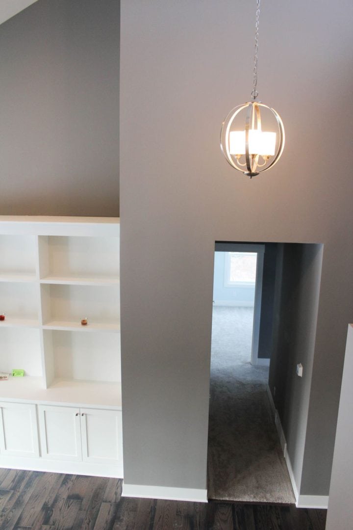 Livingston Homes modern living room with stylish lighting and built-in shelving.