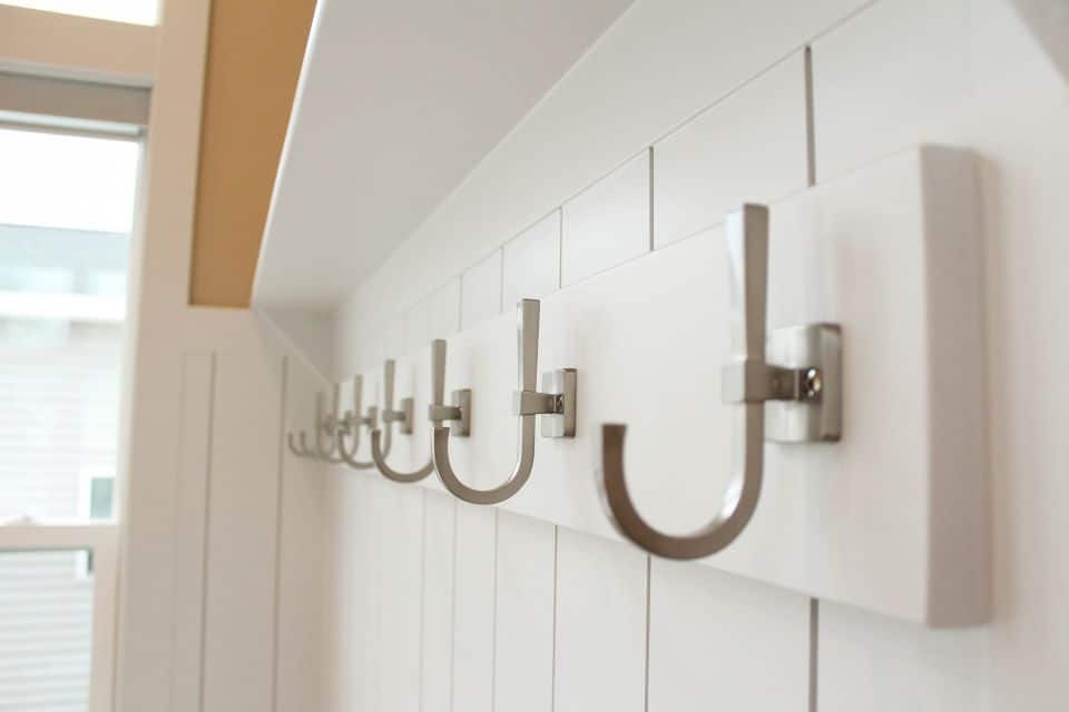 Modern coat hooks mounted on a white wall in a stylish home interior.