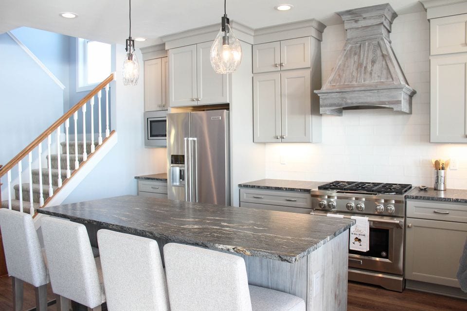 Modern kitchen with white cabinetry and stainless steel appliances.