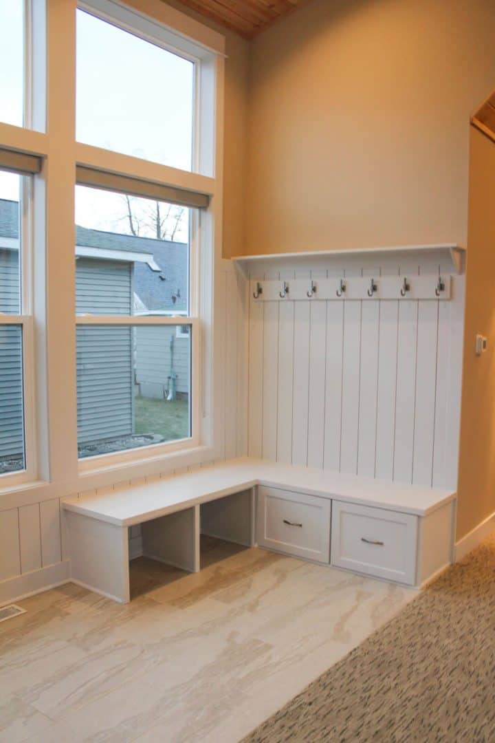 Mudroom with bench and hooks for organization and convenience.