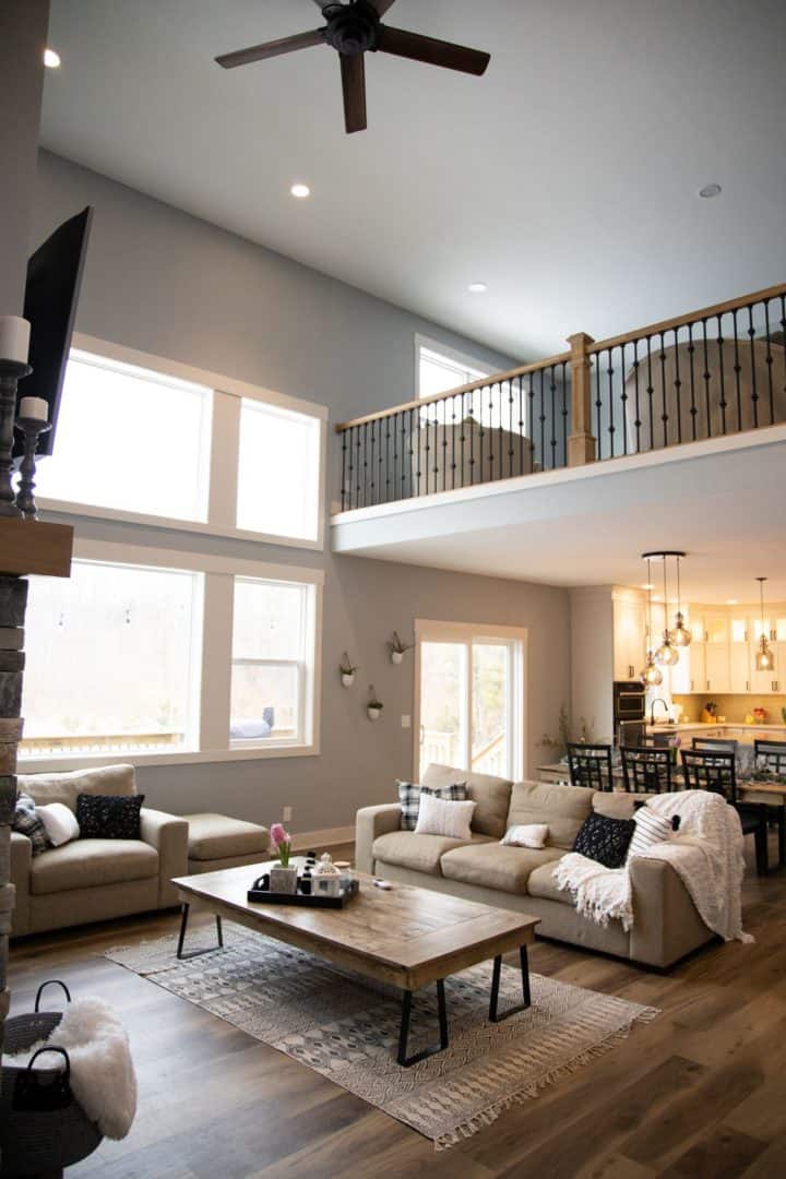 Spacious living room with high ceilings, large windows, and contemporary decor in Livingston Homes.