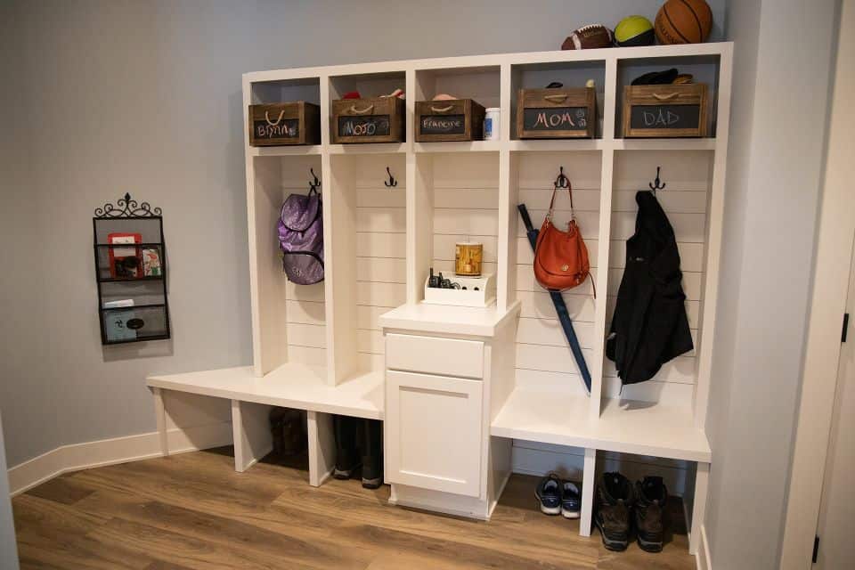 Organized mudroom with storage benches, hooks, and labeled bins for family essentials.