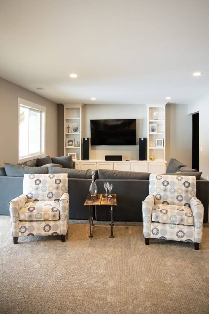 Livingston Homes living room featuring a large flat-screen TV, comfortable seating, and stylish deco.