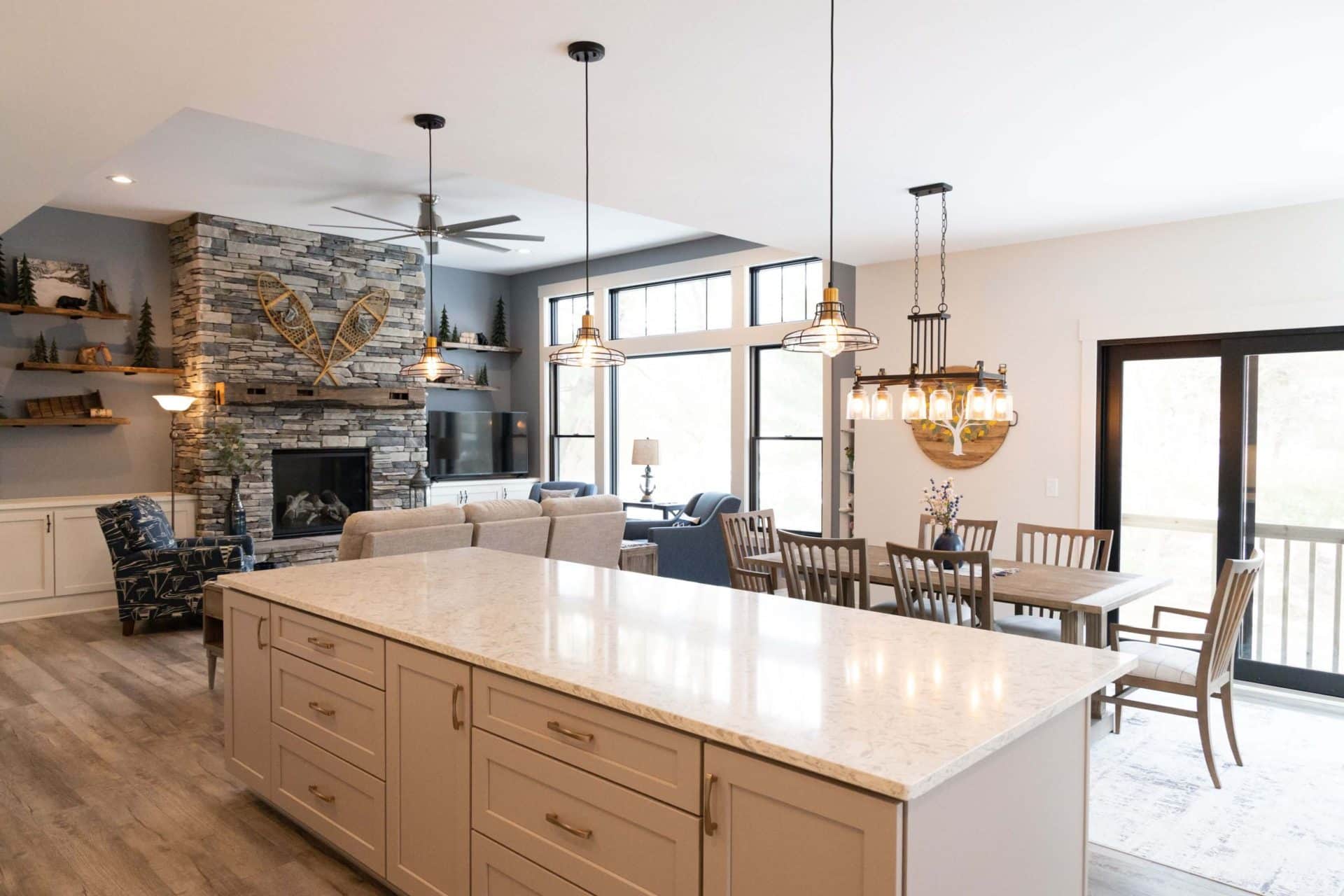 Livingston Homes modern open-concept living room with kitchen and large windows.