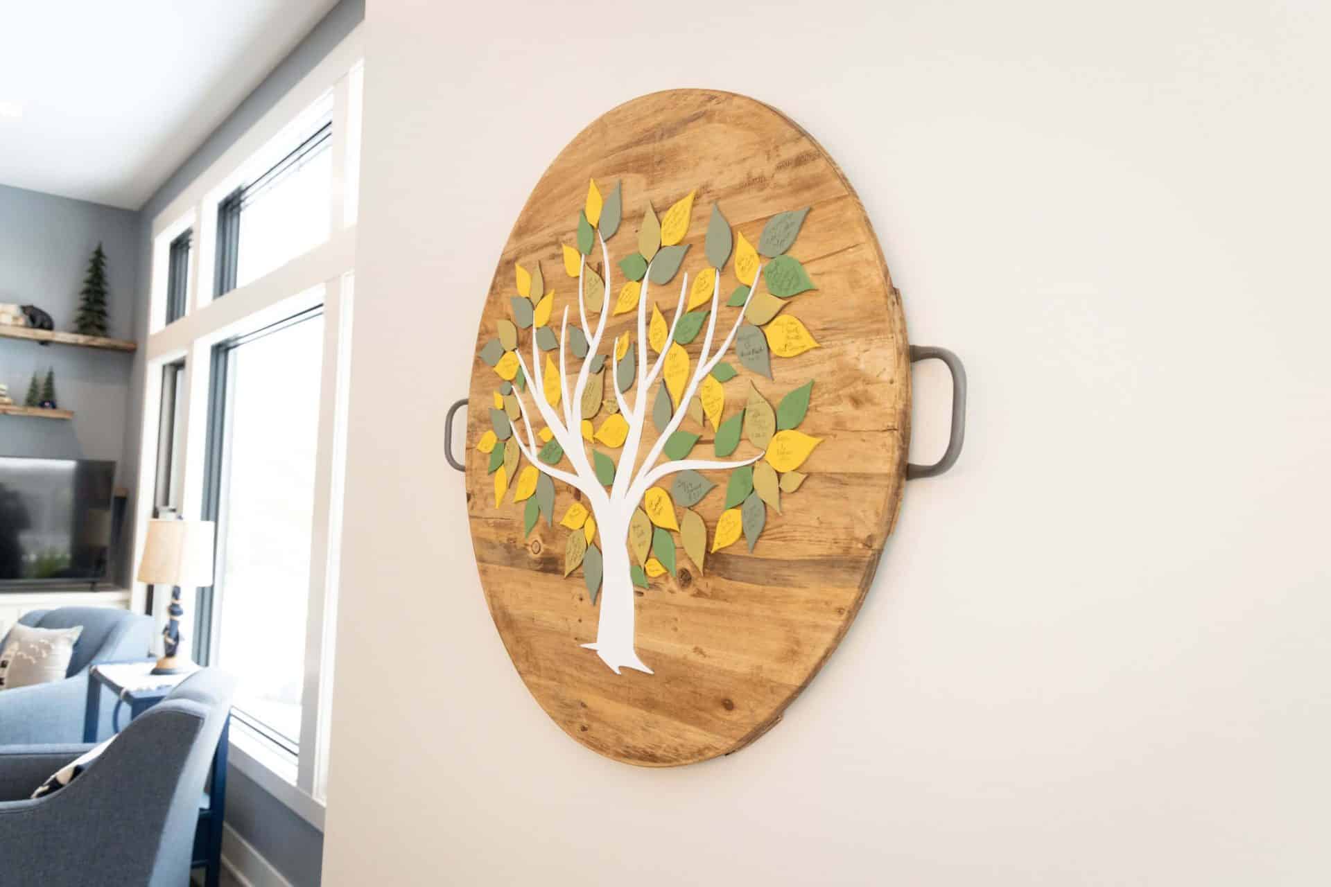 Modern wooden wall art with colorful leaf design in living room.