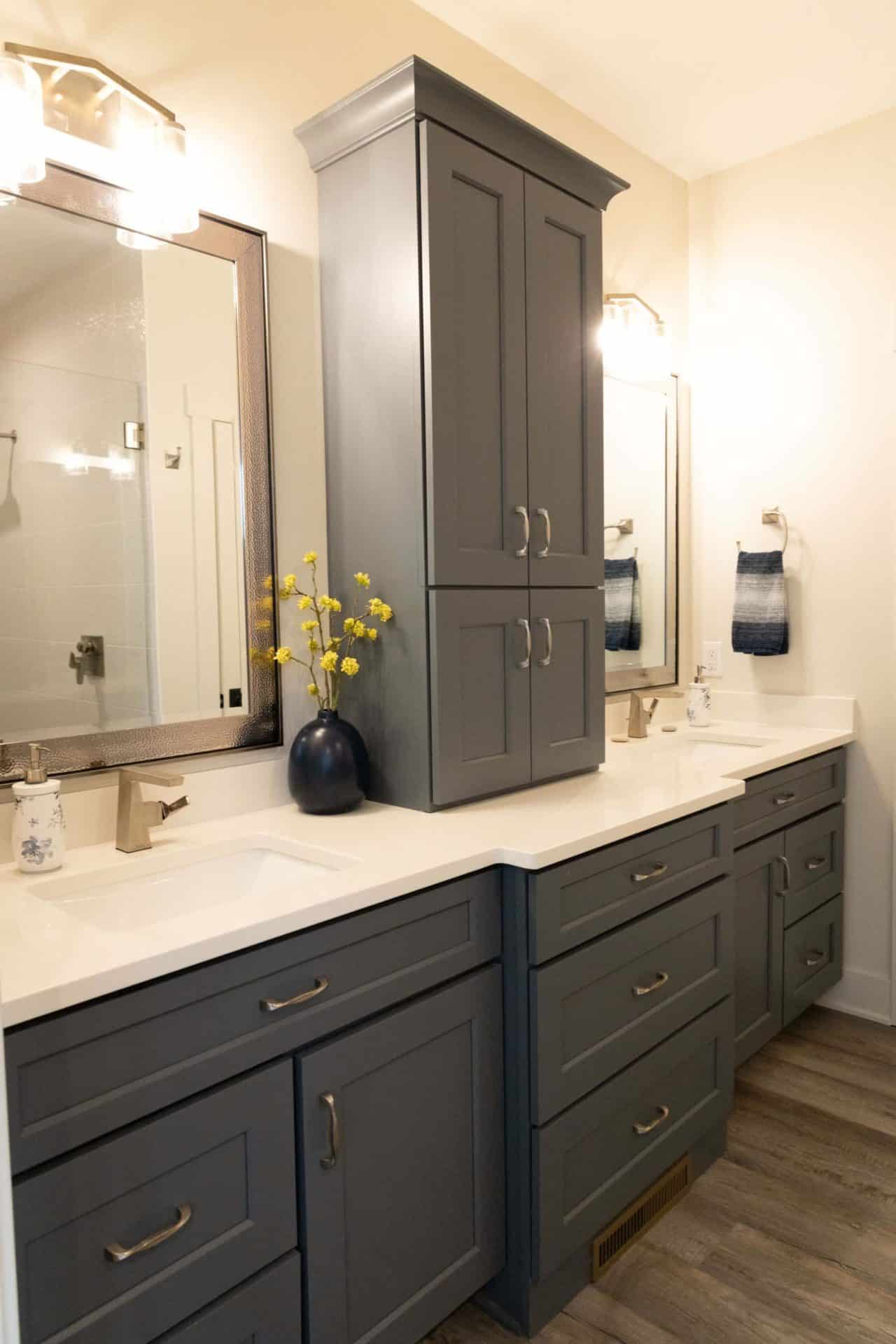 Elegant gray bathroom vanity with double sinks and ample storage space.