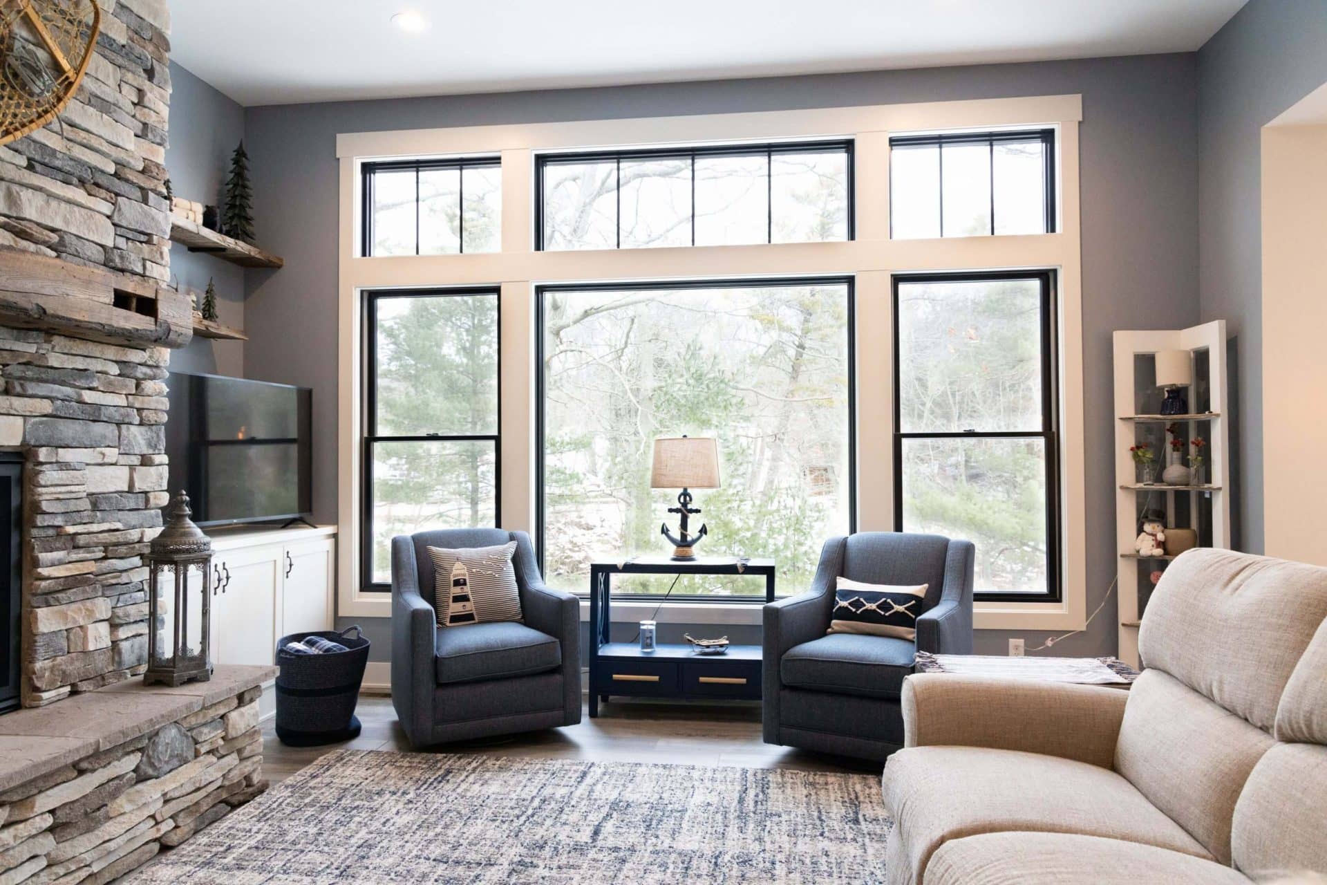 Living room with expansive windows, stylish furniture, and natural light for a comfortable living sp.