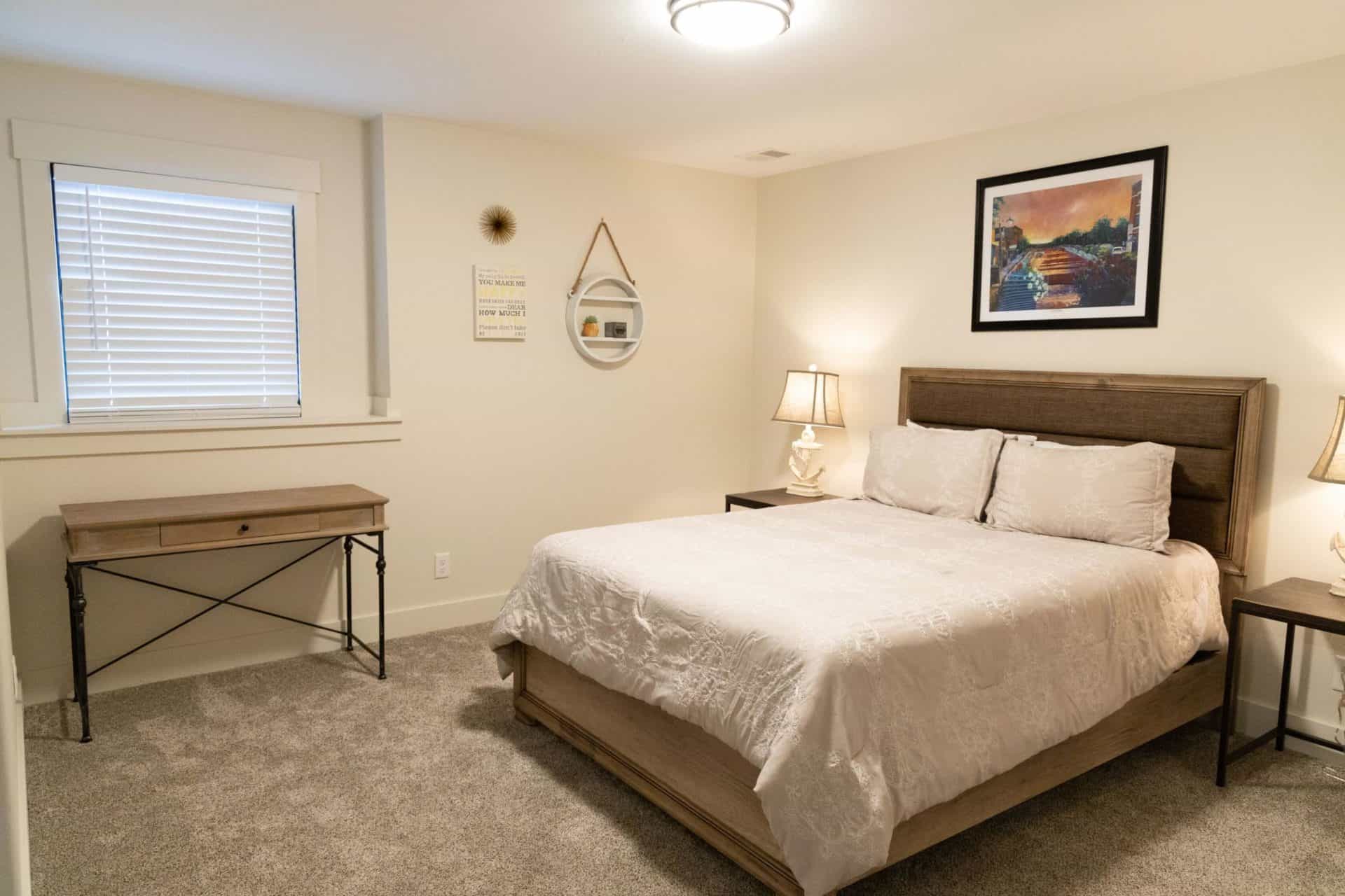 Cozy bedroom featuring a large bed, soft lighting, and minimalist decor for comfortable living space.
