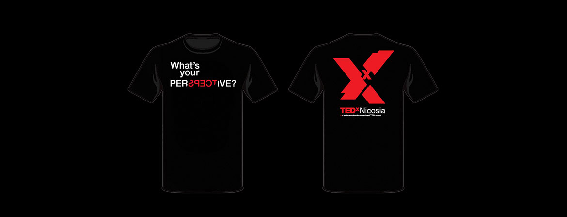 A black T-shirt with white and red text, featuring a large red X and the TEDxNicosia logo.