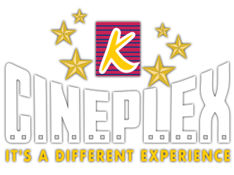 A group of people sitting in a cinema theatre watching a movie on a large screen.