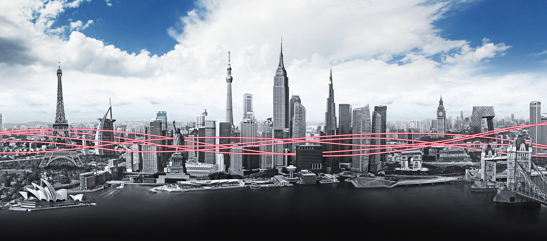 A panoramic view of New York City skyline with iconic skyscrapers and bridges under a partly cloudy sky.